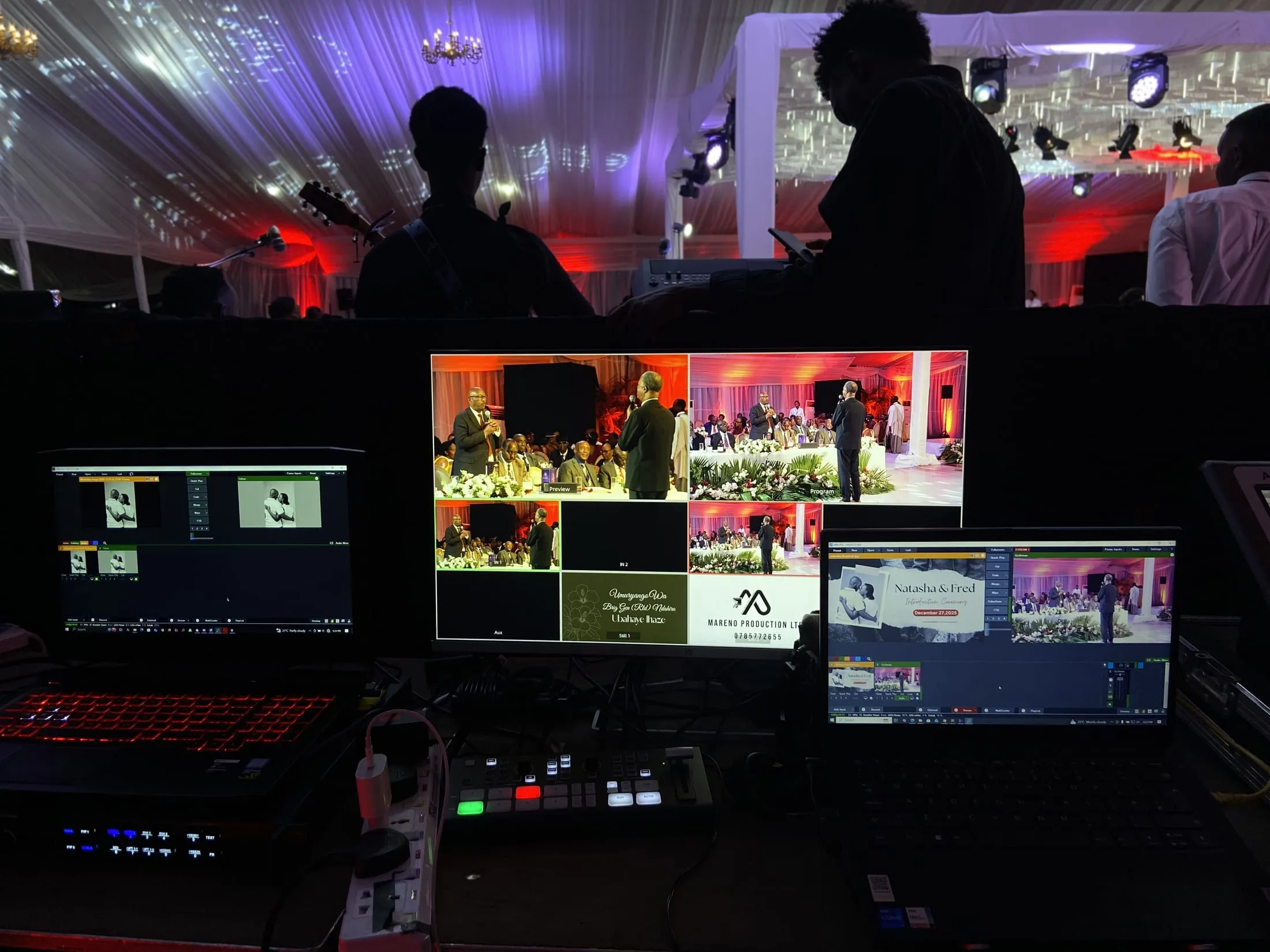 Broadcast switcher at Natasha and Fred's introduction ceremony, with a live band and lit tent in the background