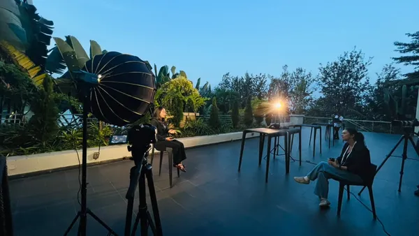Outdoor interview setup with lighting and camera at dusk